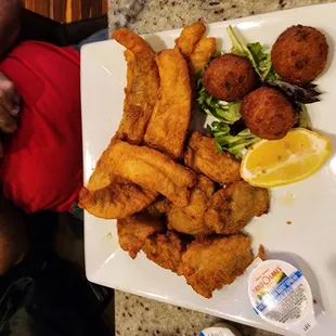 Fried pollock,  fried oysters and baked potatoe with hushpuppies