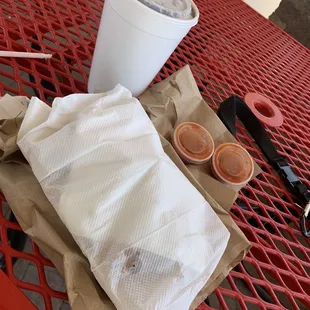 a cup of coffee and a napkin on a table