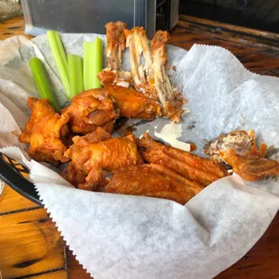 a basket of wings and celery