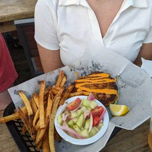 a woman holding a tray of food