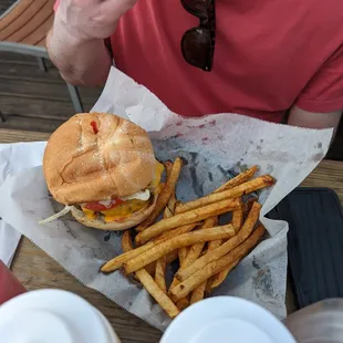 a man eating a burger and fries