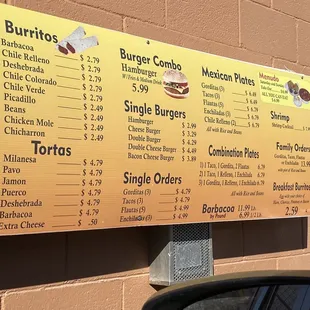 a menu on a brick wall