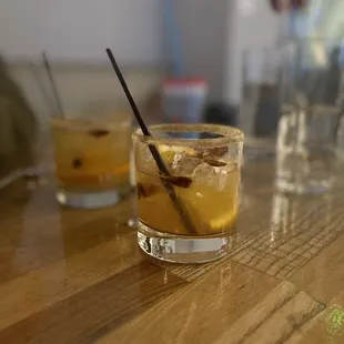 two glasses of alcohol on a table