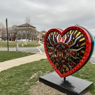 a heart - shaped sculpture in a park