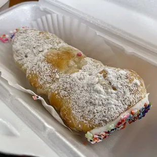 a pastry in a styrofoam container