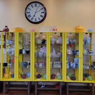 a yellow cabinet with a clock above it