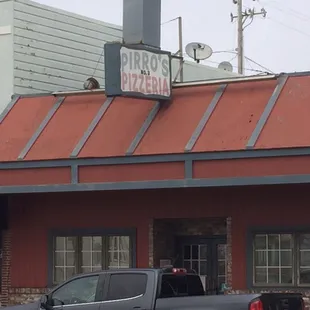 a truck parked in front of a pirros pizzeria