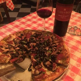 a pizza and a glass of wine