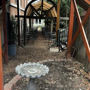 a patio with a bird bath