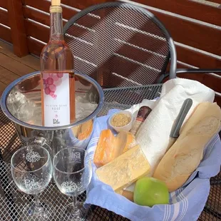 a glass of wine and a basket of food