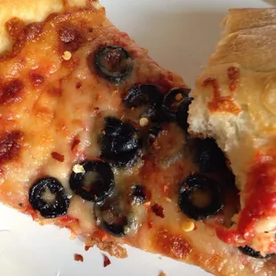 Olive pizza with pepper flakes is the
