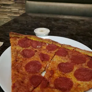 two slices of pepperoni pizza on a plate