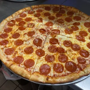 a pepperoni pizza on a pizza pan