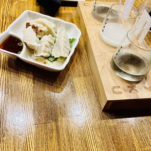 a plate of dumplings and a glass of water