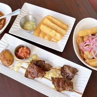 L to R: Ceviche Chino ($9), Yuca Frita ($9), Chicharrón de Pescado y Calamar ($17), and Anticuchos de Corazón ($16)