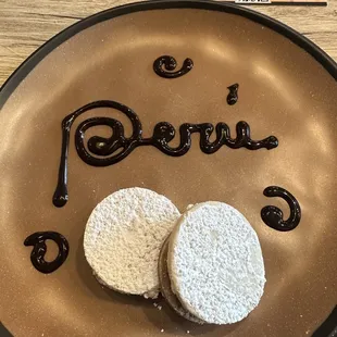 two cookies on a plate with the word pisco written on it