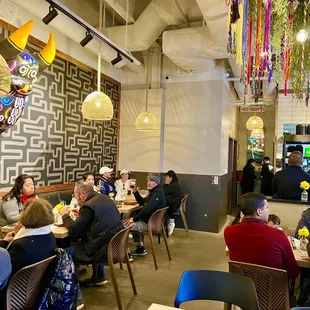 people sitting at tables in a restaurant