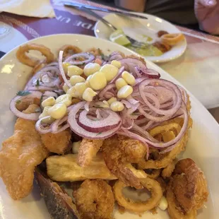 Shrimp, octopus, white fish, mussels, yucca, pickled red onions and hominy.