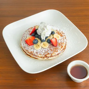 Pistachio's Buttermilk Pancakes served with fresh fruit, whipped cream &amp; powdered sugar.