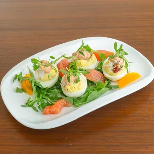 Pistachio's Dungeness Crab - Deviled Eggs, served on a bed of fresh arugula and sliced citrus.