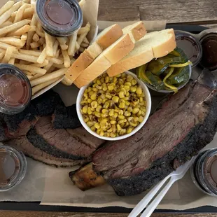 Dino rib and brisket, with fries and esquite for sides, and bread and pickles.