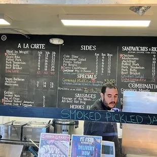 a man standing in front of a menu