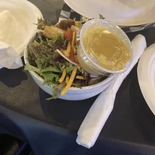 a salad with dressing in a bowl