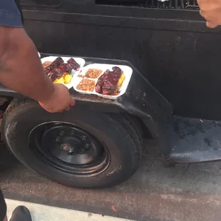 a man holding a tray of food