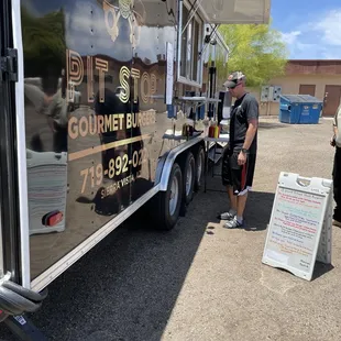 a man standing in front of a food truck