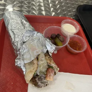 Falafel wrap with sauces and pickles &amp; olives