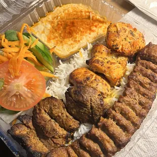 The delicious kebab combo. Comes with chicken, steak and ground meat kebab over rice. Hummus and salad on the side.