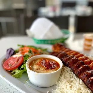 a plate of grilled meat and rice