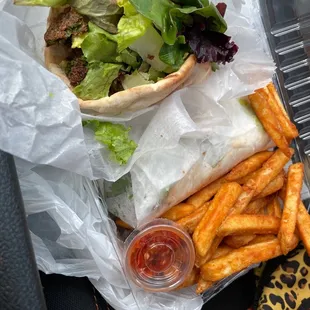 Delicious Falafel Wrap w fries to go! very fresh &amp; yummy- its two portions of falafel separately wrapped.... good to share ;)