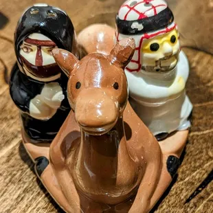 three salt and pepper shakers