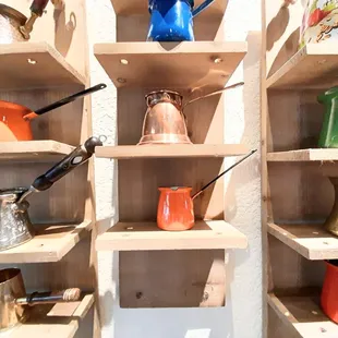 a shelf of pots and pans