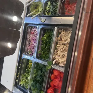 a variety of salads in containers