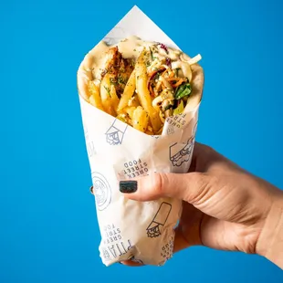 a hand holding a burrito