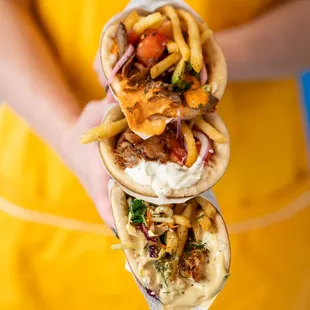 a person holding two pitas