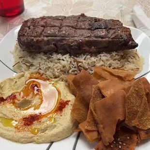 Ribeye with hummus, rice and pita chips