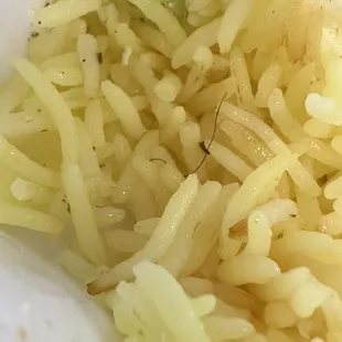 Thick black hair in rice.