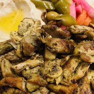 Chicken Shawarma plate with Hummus and pickled vegetables and garlic sauce on the side. This is so delicious