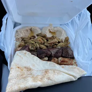 pita and meat in a plastic container