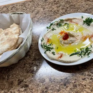 a bowl of hummus and pita bread