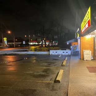 Rat running across parking lot from business