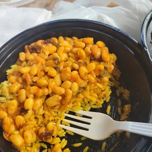  bowl of beans and rice with a fork