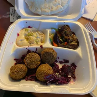 To go order: bottom falafel and braised red cabbage  Top hummus and eggplant salad   Under $7 It's good!
