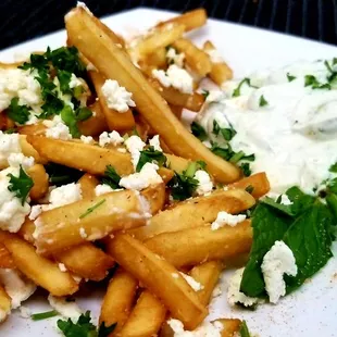 Greek Fries with garlic sauce, feta cheese, parsley and Tzatziki