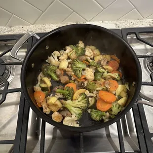 Us cooking our raw vegetables.
