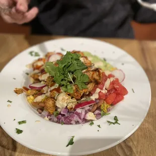 a white plate of food on a wooden table