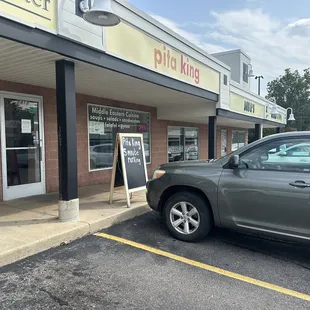 a car parked in front of a restaurant